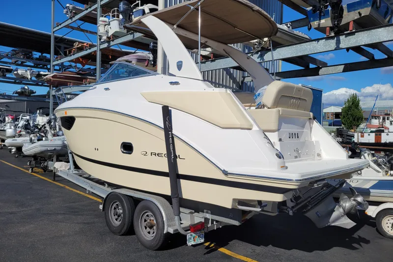 Slide: The Image of 2018 Regal 26 Express boat on trailer in marina storage area. - 2