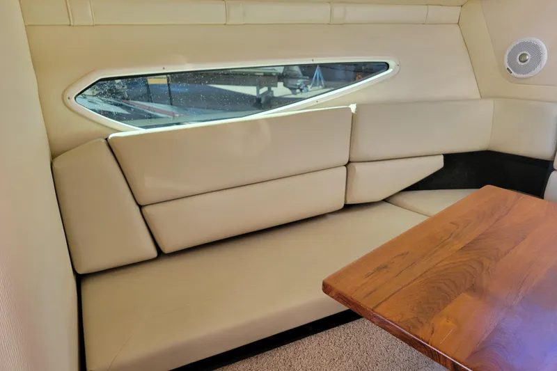 Slide: The Image of 2018 Regal 26 Express cabin with beige seating and wooden table. - 21