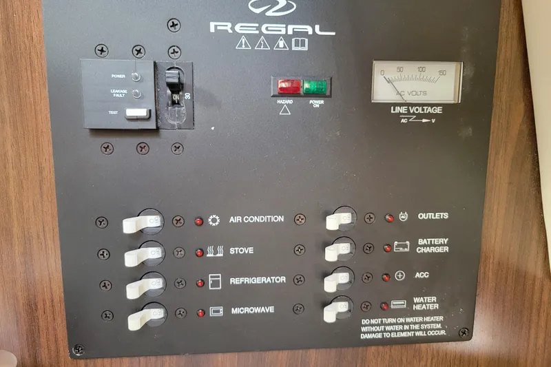 Slide: The Image of 2018 Regal 26 Express boat interior with kitchenette, featuring a compact fridge and sink. - 28