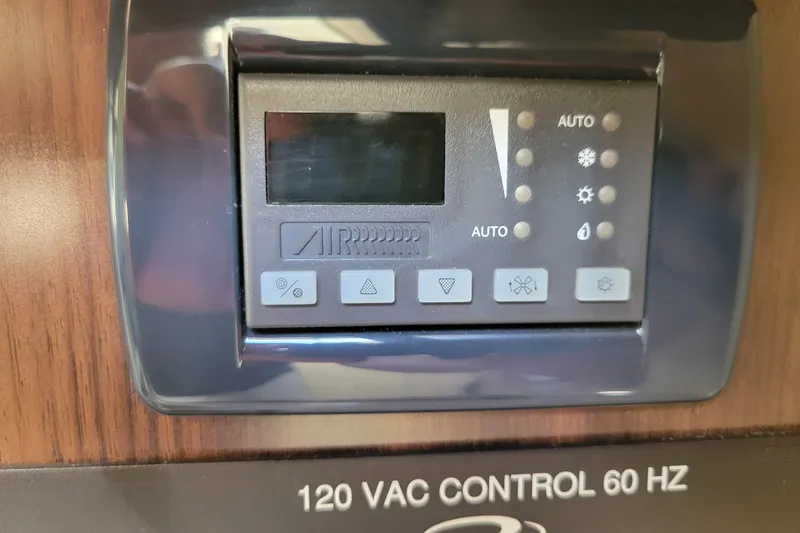 Slide: The Image of Control panel of a 2018 Regal 26 Express boat, featuring various switches and voltage meter. - 29