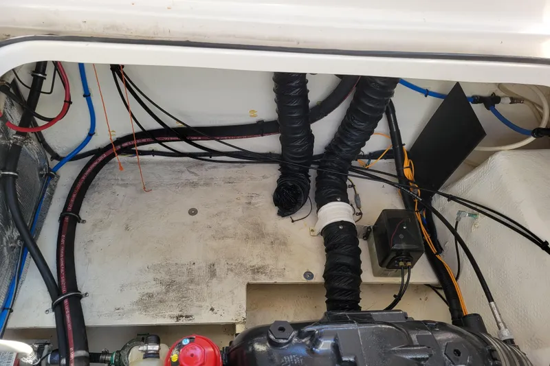 Slide: The Image of Engine compartment of a 2018 Regal 26 Express boat with visible wiring and hoses. - 42