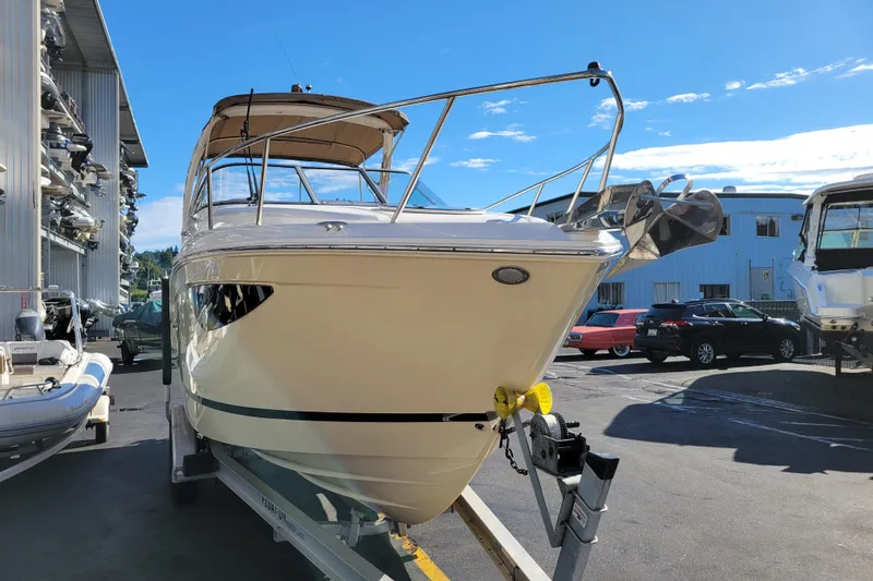 Slide: The Image of 2018 Regal 26 Express boat on trailer in marina under clear blue sky. - 5