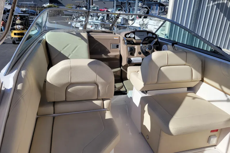 Slide: The Image of 2018 Regal 26 Express boat interior with beige seating and modern dashboard. - 6