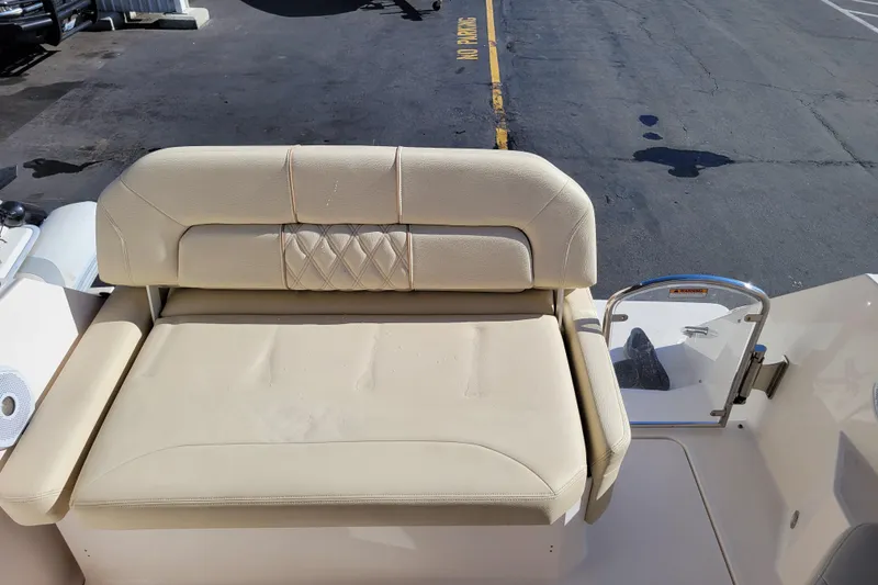 Slide: The Image of 2018 Regal 26 Express boat with beige seating and rear access gate. - 7