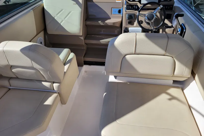 Slide: The Image of Interior of 2018 Regal 26 Express boat with beige seating and steering wheel. - 8