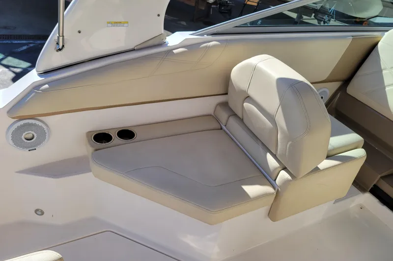 Slide: The Image of 2018 Regal 26 Express boat interior with beige seating and cup holders. - 9