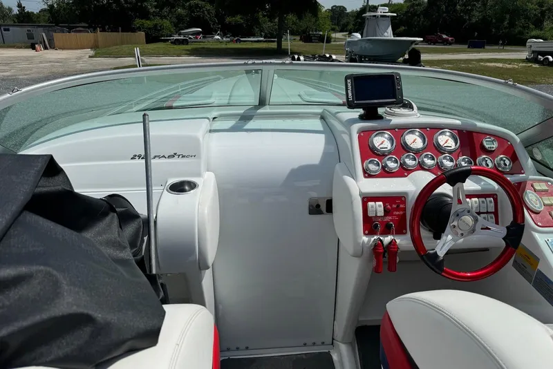 Slide: The Image of 2005 Formula 292 FASTech boat dashboard with red accents and navigation equipment. - 3