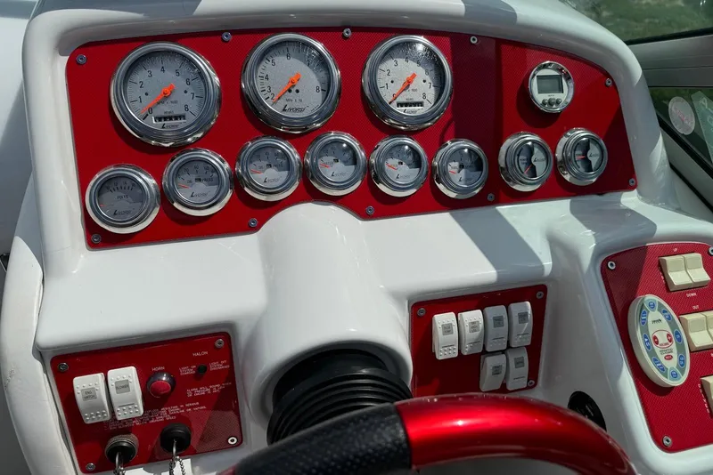 Slide: The Image of Dashboard of a 2005 Formula 292 FASTech boat with red accents and multiple gauges. - 4