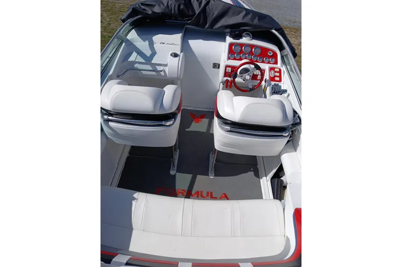 Slide: The Image of 2005 Formula 292 FASTech boat interior with white seating and red dashboard accents. - 5