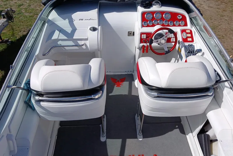Slide: The Image of 2005 Formula 292 FASTech boat interior with white seats and red dashboard accents. - 6