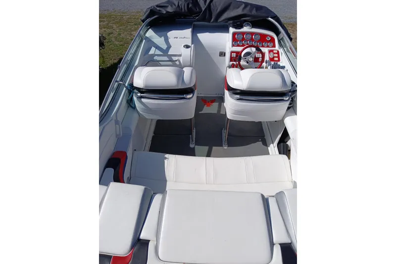 Slide: The Image of 2005 Formula 292 FASTech boat interior with white seating and red dashboard accents. - 8