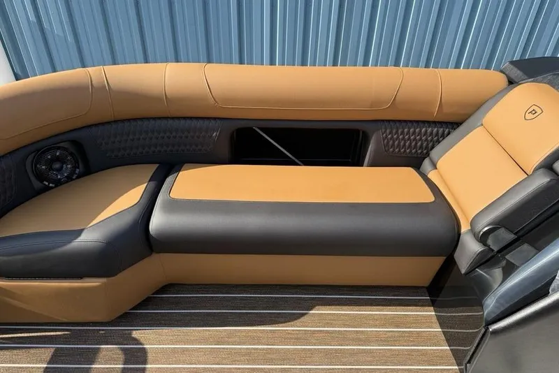 Slide: The Image of Luxurious seating on 2026 Premier 250 Solaris RS CL boat, featuring tan and black upholstery. - 14