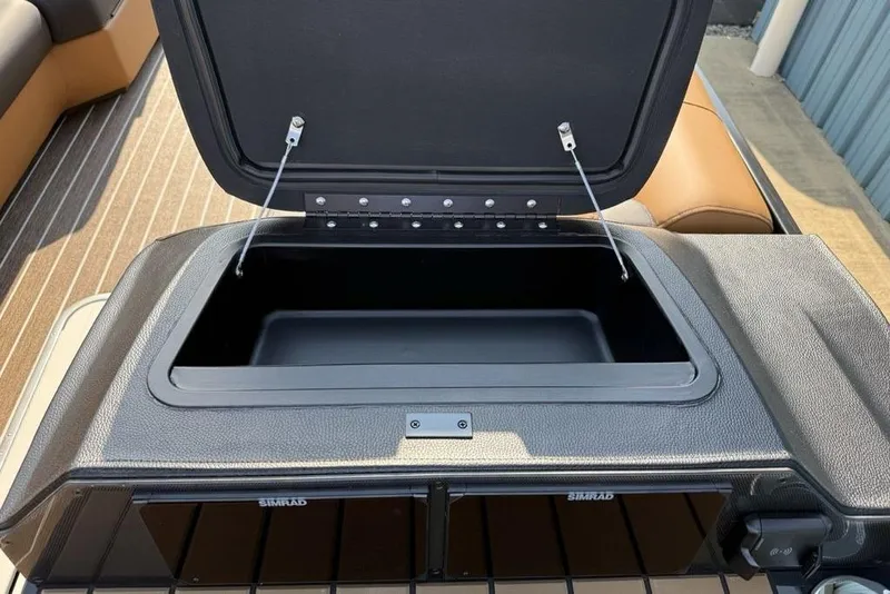 Slide: The Image of Open storage compartment on 2026 Premier 250 Solaris RS CL boat dashboard. - 21