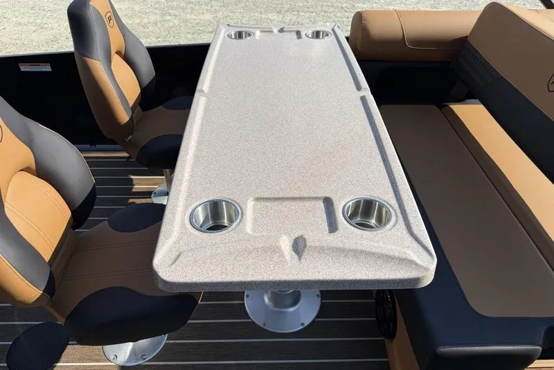 Slide: The Image of Premier 250 Solaris RS CL 2026 boat interior with seating and table featuring cup holders. - 34