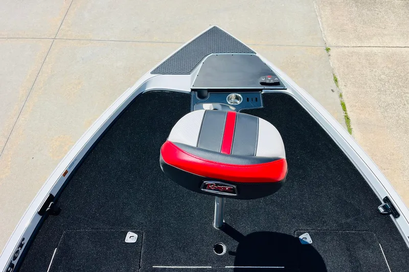 Slide: The Image of 2025 Ranger Z520 boat deck with red and gray seat, black carpet, and control panel. - 11
