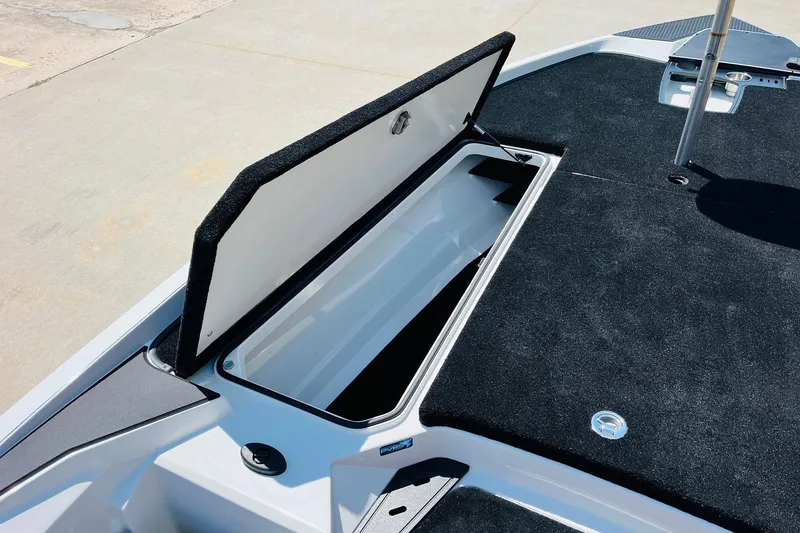Slide: The Image of 2025 Ranger Z520 boat storage compartment with open lid, showcasing spacious interior. - 13