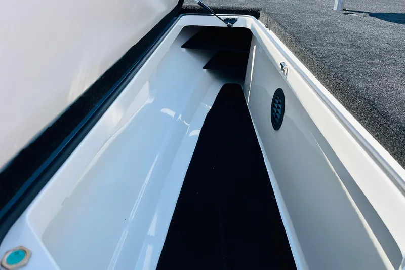 Slide: The Image of 2025 Ranger Z520 boat storage compartment with carpeted interior and ventilation. - 14