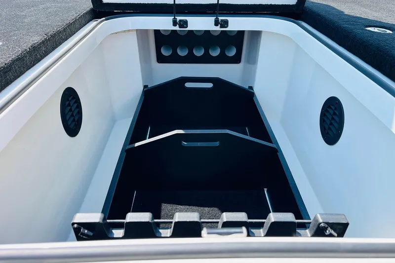 Slide: The Image of 2025 Ranger Z520 boat storage compartment with organized dividers and ventilation. - 16