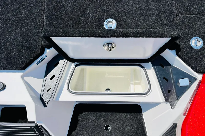 Slide: The Image of 2025 Ranger Z520 boat storage compartment with black carpet and metal latches. - 24