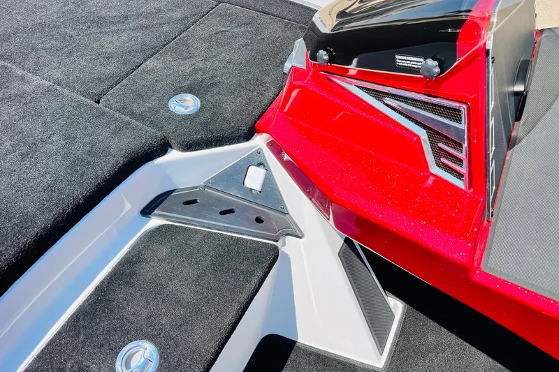 Slide: The Image of 2025 Ranger Z520 boat interior with red and black detailing, featuring carpeted surfaces. - 25