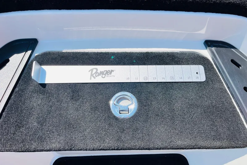 Slide: The Image of 2025 Ranger Z520 boat deck with measuring tool and latch. - 26