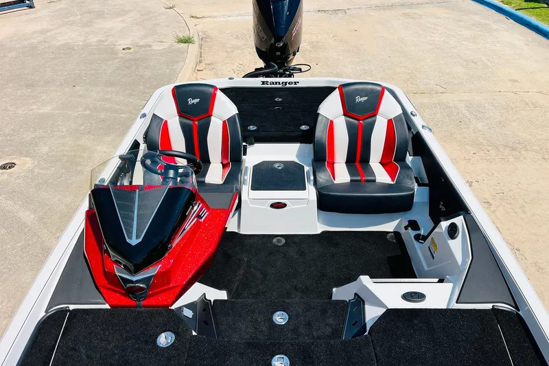 Slide: The Image of 2025 Ranger Z520 boat interior with red and black seats, sleek design. - 27