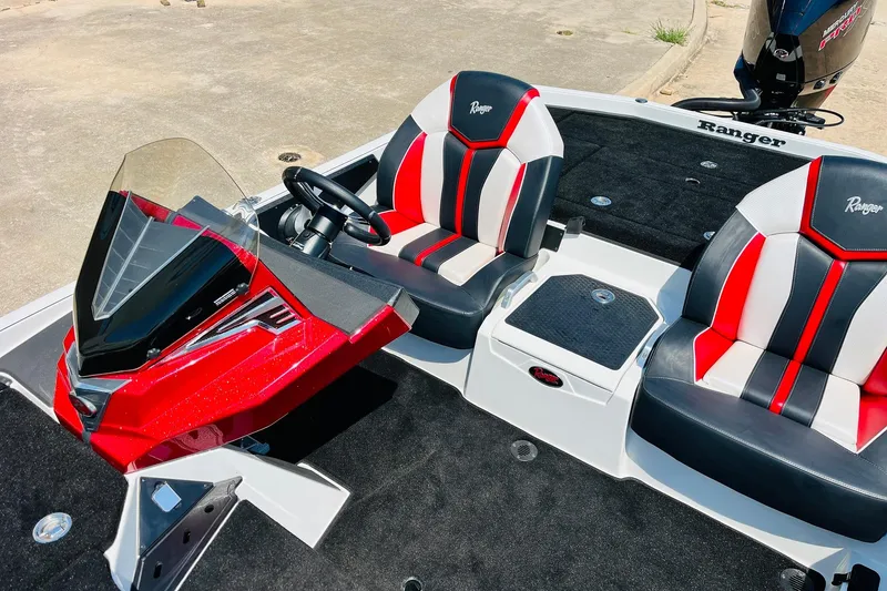 Slide: The Image of 2025 Ranger Z520 boat interior with red and black seats, steering wheel, and console. - 29