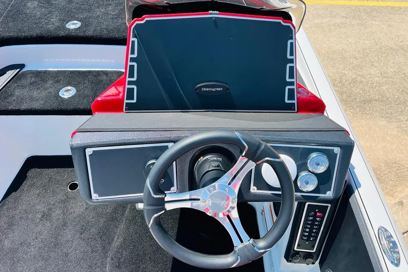Slide: The Image of 2025 Ranger Z520 boat dashboard with steering wheel and control panel. - 32