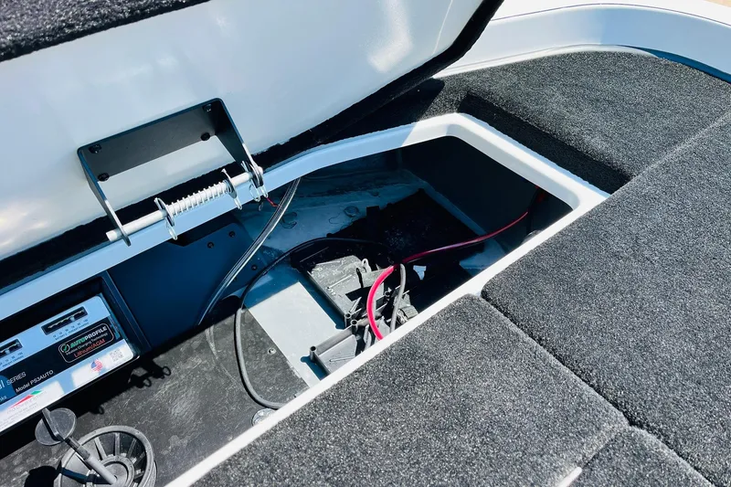 Slide: The Image of Open storage compartment in 2025 Ranger Z520 boat, showing battery and wiring. - 37