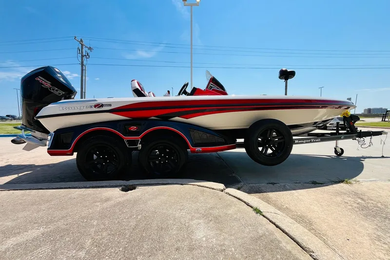 Slide: The Image of 2025 Ranger Z520 boat on trailer, sleek design, red and black accents, sunny day. - 4