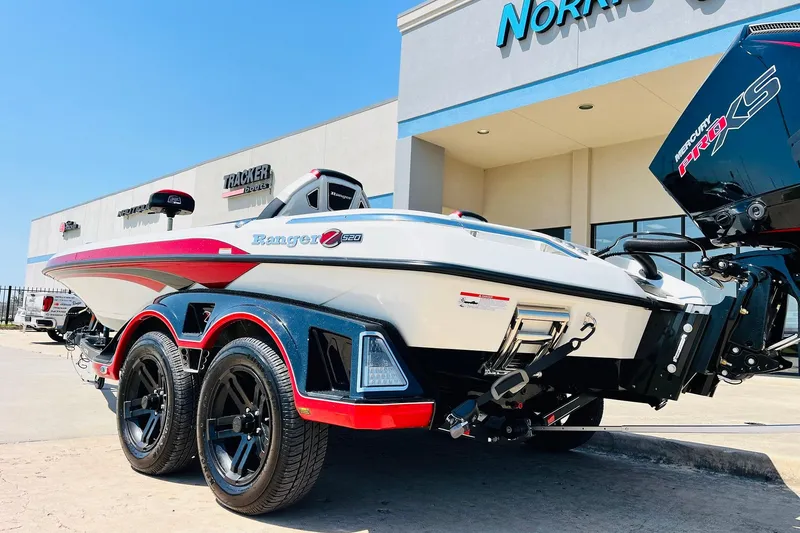 Slide: The Image of 2025 Ranger Z520 boat with dual axle trailer, parked outside dealership. - 8