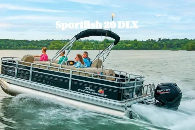 The Image of 2026 Sun Tracker Sportfish™ 20 DLX pontoon boat cruising on a lake with passengers. - 1