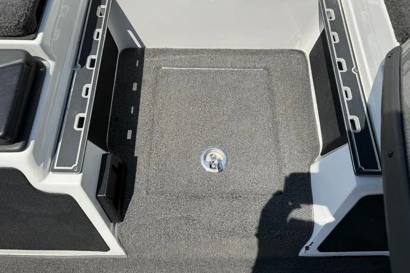 Slide: The Image of 2014 Skeeter FX 20 boat interior with carpeted flooring and storage compartments. - 11
