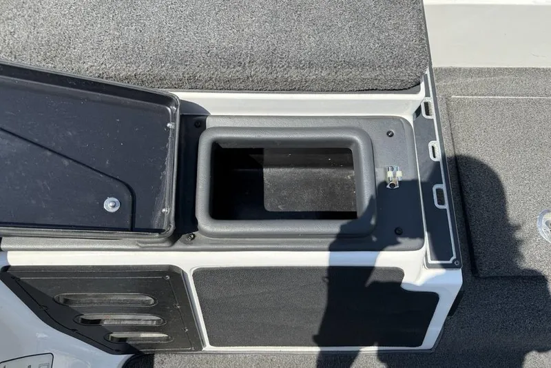Slide: The Image of 2014 Skeeter FX 20 boat storage compartment with open lid, showing interior space. - 15