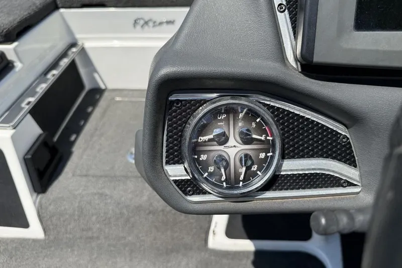 Slide: The Image of 2014 Skeeter FX 20 dashboard with gauge cluster, featuring carbon fiber accents. - 16