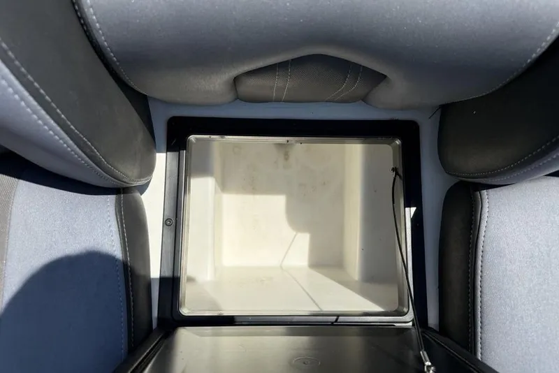 Slide: The Image of 2014 Skeeter FX 20 boat storage compartment with cushioned seating. - 21