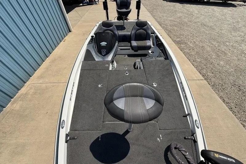 Slide: The Image of 2014 Skeeter FX 20 fishing boat with seating and storage, parked on concrete. - 22