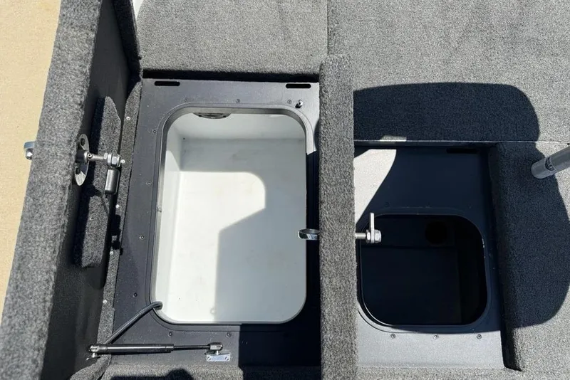 Slide: The Image of 2014 Skeeter FX 20 boat storage compartments with open lids, showcasing interior space. - 23