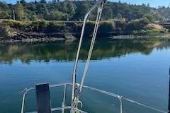 Slide: The Image of Dufour 40 Performance 2004 sailboat on calm water with scenic forested background. - 14