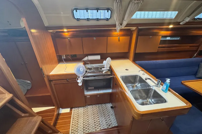 Slide: The Image of Interior of 2004 Dufour 40 Performance yacht with kitchen and seating area. - 17