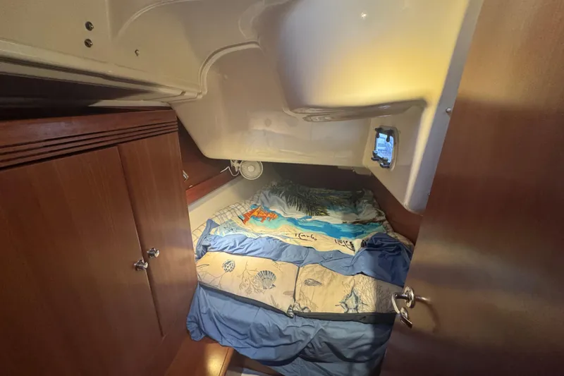 Slide: The Image of Cozy cabin interior of 2004 Dufour 40 Performance sailboat with nautical-themed bedding. - 18
