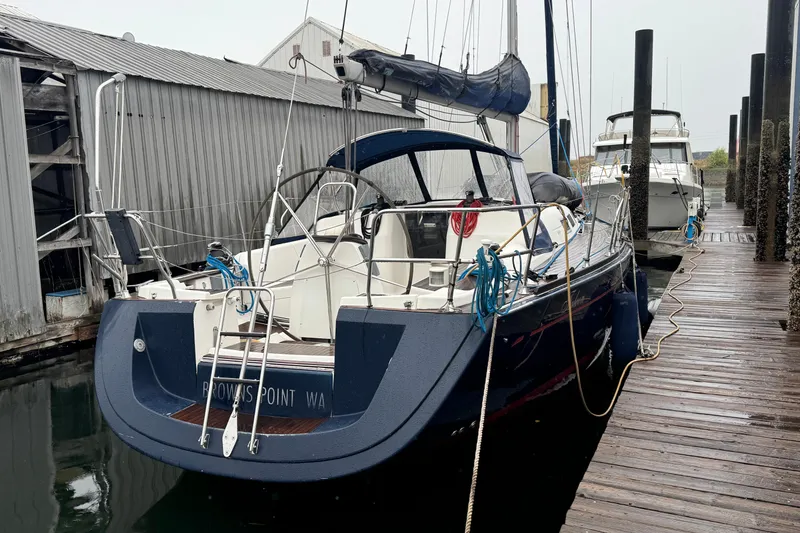 Slide: The Image of 2004 Dufour 40 Performance sailboat docked at marina, rear view. - 2