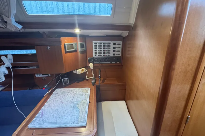 Slide: The Image of Navigation station inside 2004 Dufour 40 Performance yacht with chart and control panel. - 20