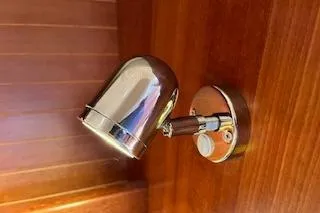 Slide: The Image of Chrome wall light fixture on Dufour 40 Performance yacht, 2004 model, with wooden paneling. - 21
