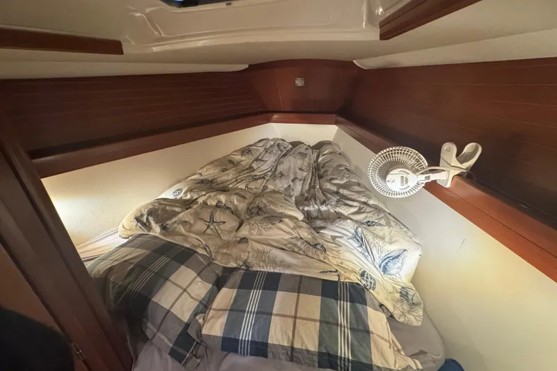Slide: The Image of Cozy cabin interior of 2004 Dufour 40 Performance sailboat with bedding and fan. - 25