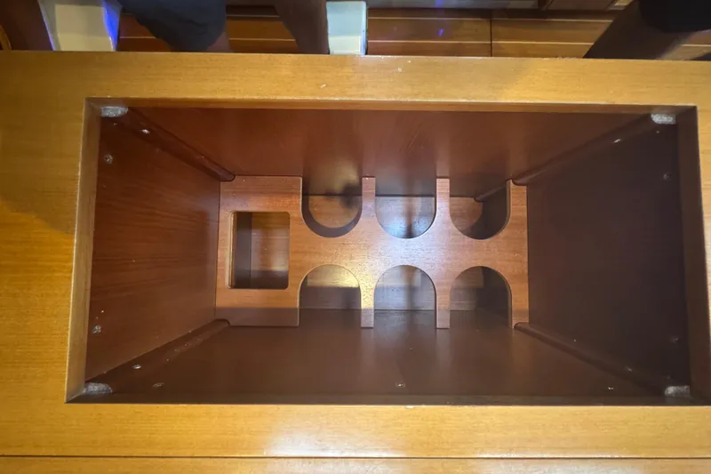 Slide: The Image of Wooden wine rack inside 2004 Dufour 40 Performance yacht, showcasing elegant craftsmanship. - 31