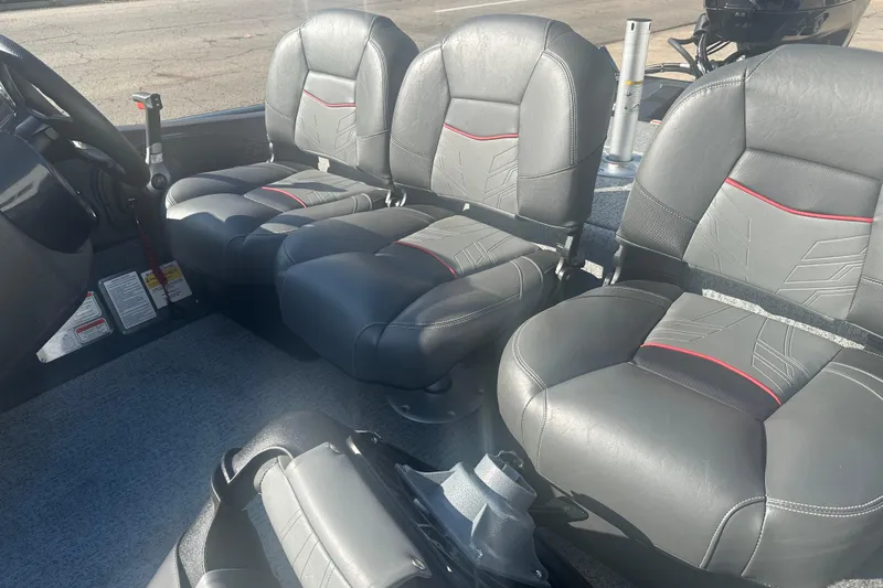 Slide: The Image of 2024 Tracker Pro Team 175 TF boat interior with gray and red-accented seats. - 3