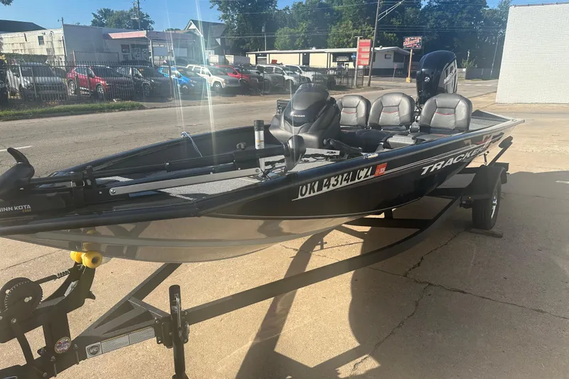 Slide: The Image of 2024 Tracker Pro Team 175 TF boat on trailer, parked outdoors in a lot. - 6