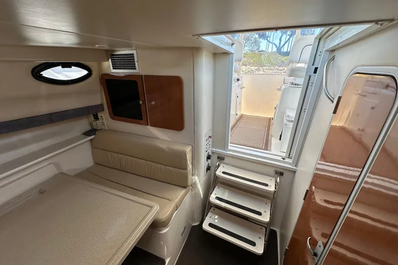 Slide: The Image of Interior of 2003 Wellcraft 330 Coastal boat, featuring seating and access stairs. - 15