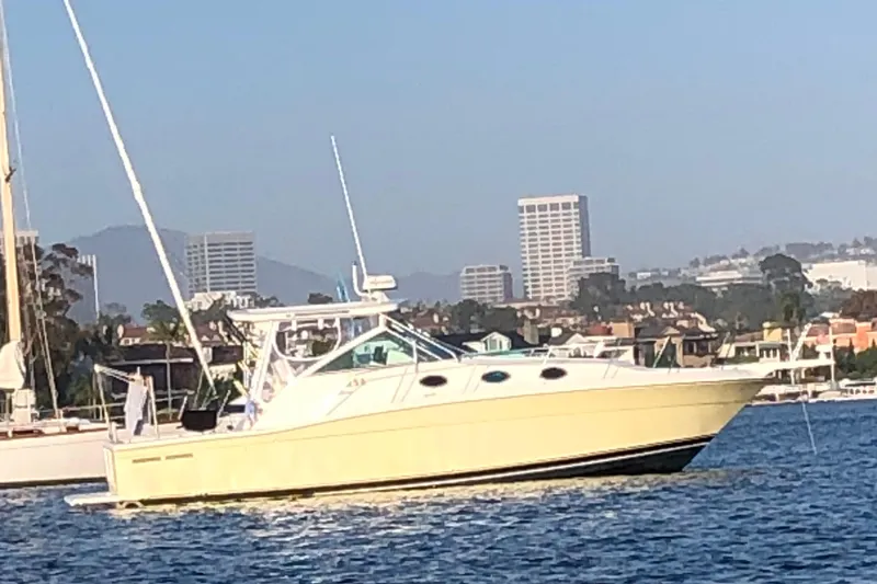 Slide: The Image of 2003 Wellcraft 330 Coastal boat on water with cityscape background. - 21
